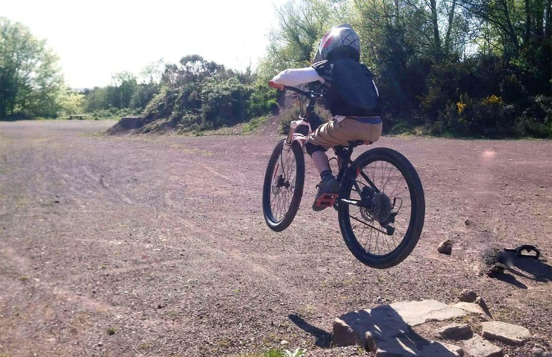 Child jumping a mountain bike